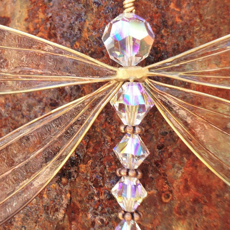 Decorative butterfly with crystal-like wings on a rusted metal background